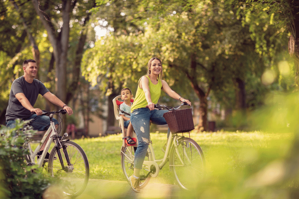 This image: an illustrative image of a family cycling through
					 a green space between some trees.
					 The map: The map has zoomed
					 back out to the full site and now shows an illustrative masterplan
					 showing where the proposed new homes will be in the west of the
					 site, and the green buffer in the east, with a proposed relief
					 road running between them. The existing and proposed public rights
					 of way are highlighted in grey and orange. There are interactive
					 markers around the site boundary, which describe each point of access
					 into the site when clicked on.